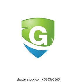 G initial swoosh shield logo blue green