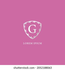 G Letter Intial logo design template. Luxury silver decorative floral shield illustration. Suitable for Insurance, fashion and beauty product. isolated on pink color background