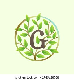 G letter logo made of twisted tree branches and green leaves in circle. Ecology vector font for vegan emblem, botanical identity, creative spring t-shirts, organic merchandise.