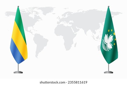 Gabon and Macau flags for official meeting against background of world map.