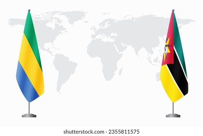 Gabon and Mozambique flags for official meeting against background of world map.