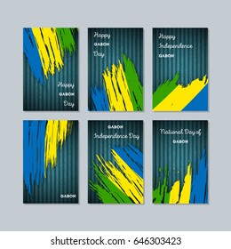 Gabon Patriotic Cards for National Day. Expressive Brush Stroke in National Flag Colors on dark striped background. Gabon Patriotic Vector Greeting Card.