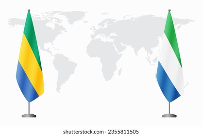 Gabon and Sierra Leone flags for official meeting against background of world map.