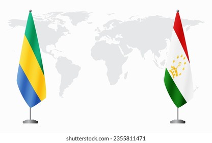 Gabon and Tajikistan flags for official meeting against background of world map.