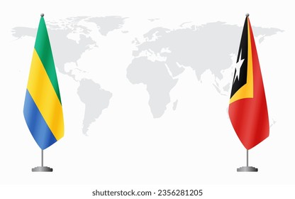 Gabon and Timor-Leste flags for official meeting against background of world map.