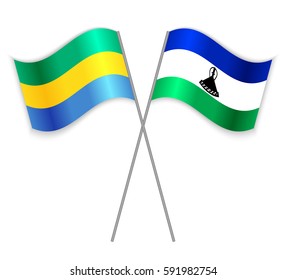 Gabonese and Basotho crossed flags. Gabon combined with Lesotho isolated on white. Language learning, international business or travel concept.