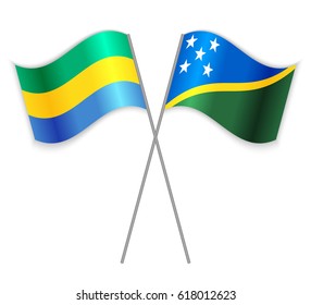Gabonese and Solomon Island crossed flags. Gabon combined with Solomon Islands isolated on white. Language learning, international business or travel concept.