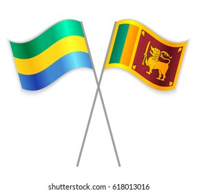 Gabonese and Sri Lankan crossed flags. Gabon combined with Sri Lanka isolated on white. Language learning, international business or travel concept.