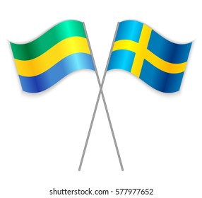 Gabonese and Swedish crossed flags. Gabon combined with Sweden isolated on white. Language learning, international business or travel concept.