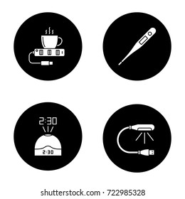 Gadgets glyph icons set. USB lamp and cup warmer, projection clock, electronic thermometer. Vector white silhouettes illustrations in black circles