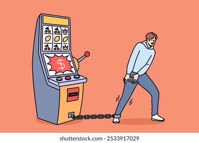 Gambling addiction of man tied with chain to slot machine made guy hostage to casino. Unhappy young human suffers from digital addiction and cannot free himself from passions to excitement