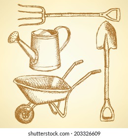 Garden fork, barrow, watering can and shovel, vintage background