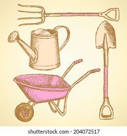 Garden fork, barrow, watering can and shovel, vintage background