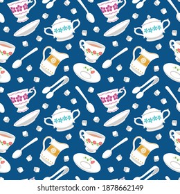 Garden tea party inspired seamless pattern depicting falling decorated china teacups and saucers, teaspoons, milk jugs, sugar lumps, bowls and tongs, on a dark blue background.