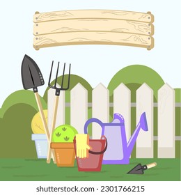 garden tools on the background of a garden or fence with a sign