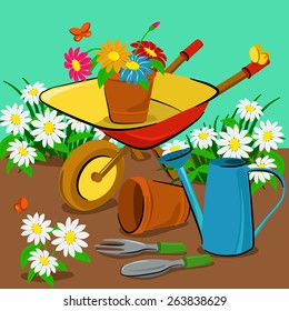 Garden tools and spring flowers in the meadow
