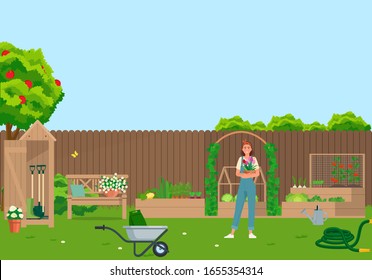 Garden with vegetables, flowers, garden tools in the backyard.