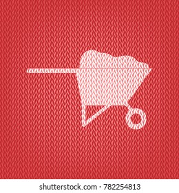 Garden wheelbarrow sign illustration. Vector. Knitted white icon on a red knitted background.