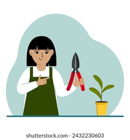 A gardener is a girl in working clothes, he has a pruner in his hand.