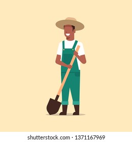 gardener holding shovel african american country man working in garden gardening eco farming concept full length