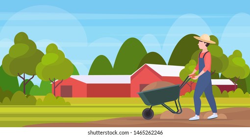 gardener man pushing wheelbarrow loaded with soil farmer working agricultural planting harvesting gardening eco farming concept farmland countryside landscape full length horizontal