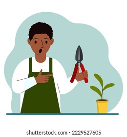 A gardener is a man in working clothes, he has a pruner in his hand. Vector flat illustration