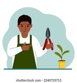 Un jardinero es un hombre vestido de trabajo, tiene un podadero en la mano. Ilustración plana del vector