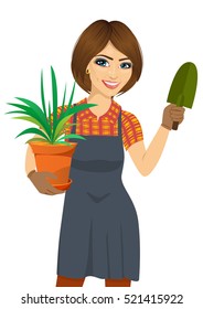 gardening beautiful woman holding green Chlorophytum plant in the pot and trowel