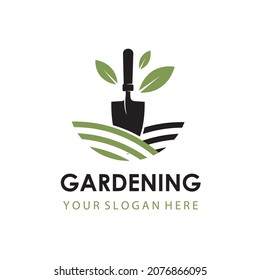 gardening emblem with trowel spade and green leaves isolated on white background