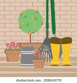 Gardening tools and flowers on the garden terrace