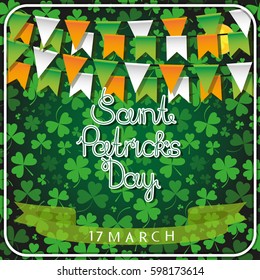A garland of festival flags in the colors of the Irish flag and an inscription of a happy St. Patrick's day against the clover background