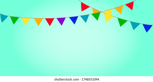 A garland of flags and pennants for a party and birthday. Carnival hanging chain on a green background. Stock Photo.