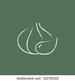 Garlic hand drawn in chalk on a blackboard vector white icon isolated on a green background.