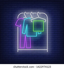 Garment on clothes rack neon sign. Shopping, fashion, garment. New collection concept. Vector illustration in neon style for advertising, online shopping, fashion show