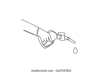 At the gas station a hand holds the pump and a drop falls down. expensive oil fuel concept