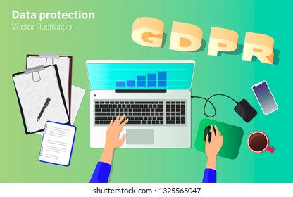 GDPR - General Data Protection Statement. Work desk with laptop, documents and hands. View from above. Workspace.