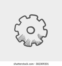 Gear sketch icon for web and mobile. Hand drawn vector dark grey icon on light grey background.