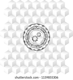 gear, team work icon inside grey badge with geometric cube white background