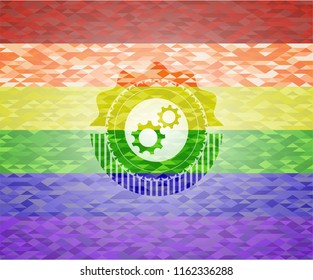 gear, team work icon inside emblem on mosaic background with the colors of the LGBT flag