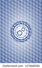 gear, team work icon inside blue polygonal badge.