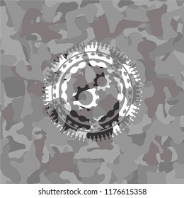 gear, team work icon inside grey camo emblem