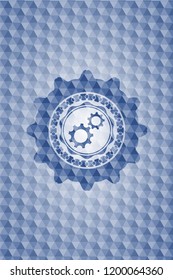 gear, team work icon inside blue polygonal badge.
