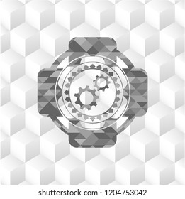 gear, team work icon inside grey emblem with cube white background