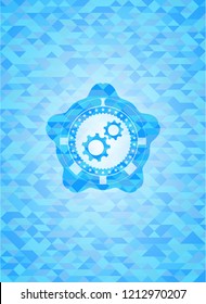 gear, team work icon inside light blue emblem with triangle mosaic background