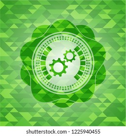gear, team work icon inside green emblem with mosaic background