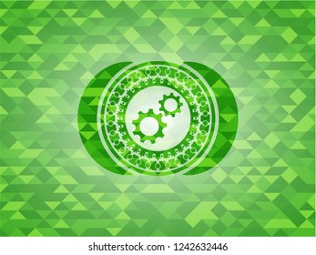 gear, team work icon inside green emblem. Mosaic background