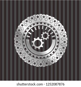 gear, team work icon inside silver emblem or badge