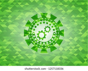 gear, team work icon inside green mosaic emblem