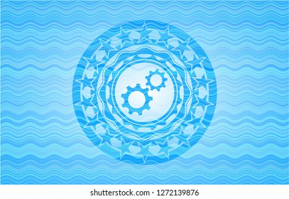 gear, team work icon inside water representation badge.