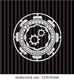 gear, team work icon inside silver badge or emblem